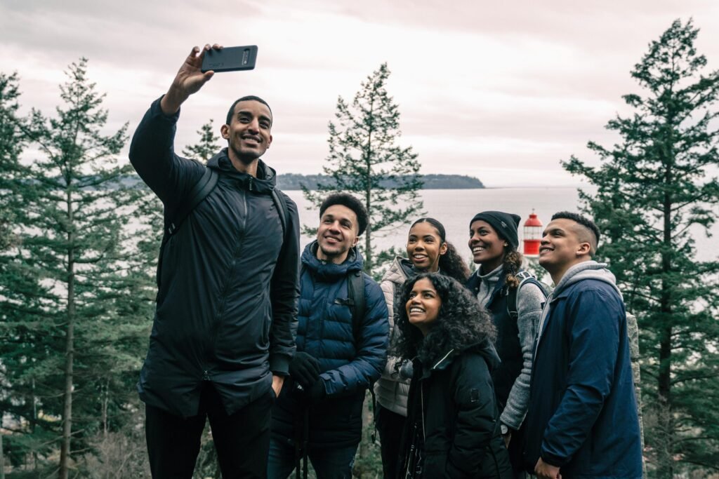 Group of friends smiling together outdoors, symbolizing support, connection, and shared personal growth.