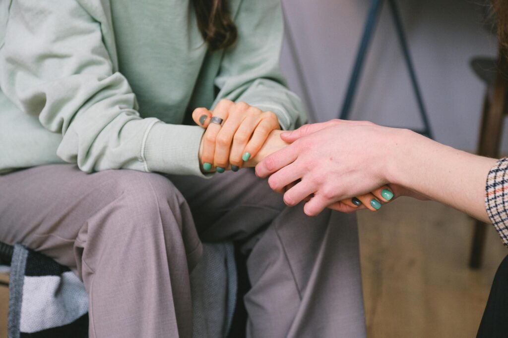 upportive hand-holding during a mental health counseling session