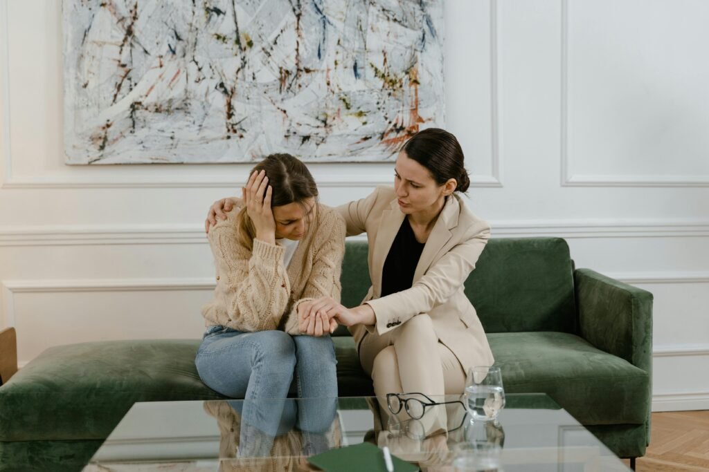 Counselor providing emotional support to a woman struggling with mental health issues. 