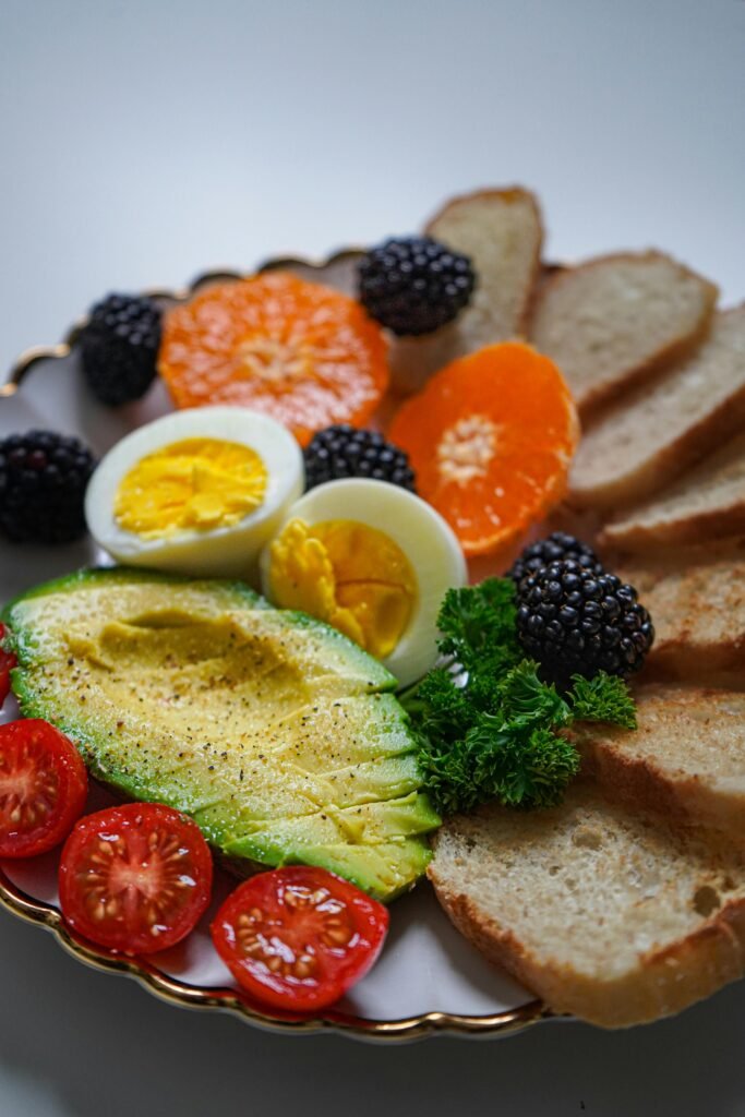 Balanced meal with avocado, eggs, fruits, and whole grains for a heart-healthy lifestyle
