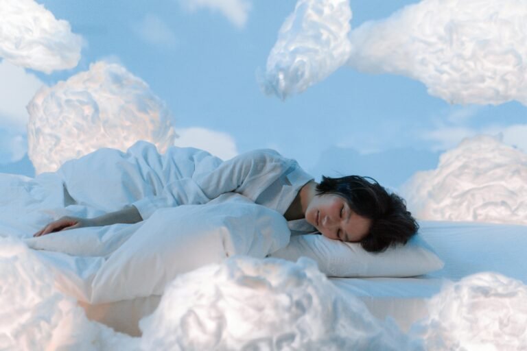 A woman peacefully sleeping in bed, surrounded by dreamy clouds in a serene blue sky.
