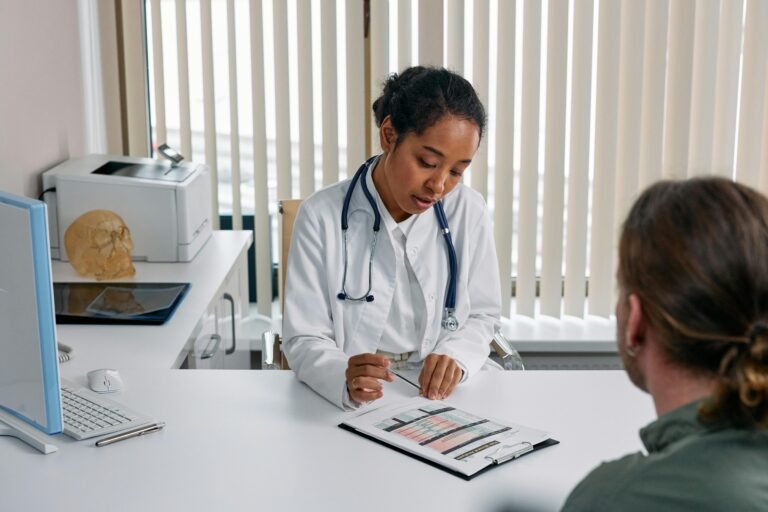 Doctor discussing medical chart with patient during a healthcare consultation.